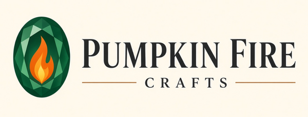 Pumpkin Fire Crafts logo centered on a light cream background, featuring a dark green oval gemstone with a yellow-orange flame and the words 'PUMPKIN FIRE CRAFTS' in dark gray.